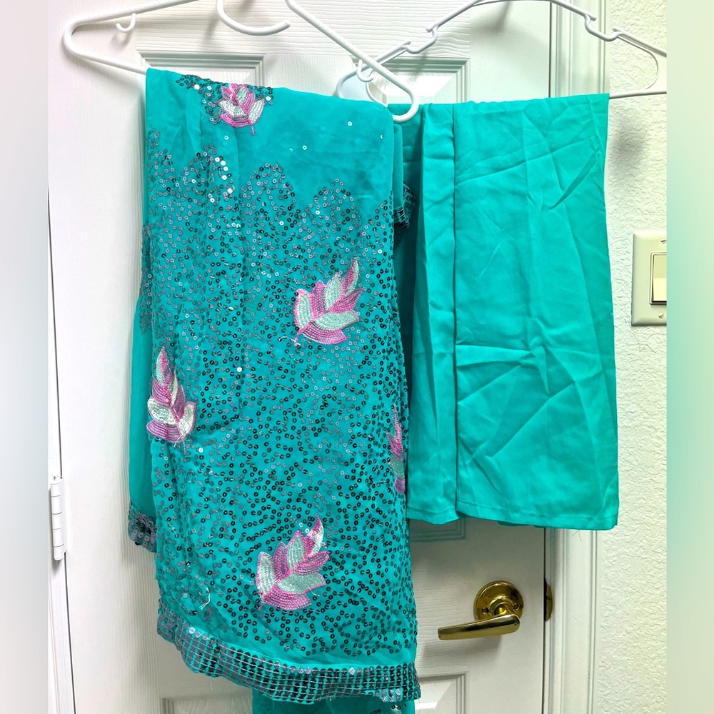 Elegant Teal Saree with Pink Embellishments